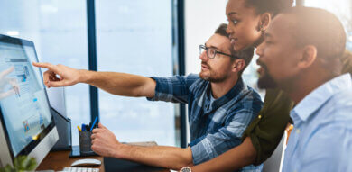 a member from a diverse team points at a screen during a heuristic evaluation