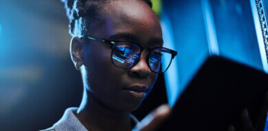 black young woman stares at AI on a tablet