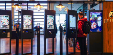 researcher orders food from display screens at a restaurant on a service safari